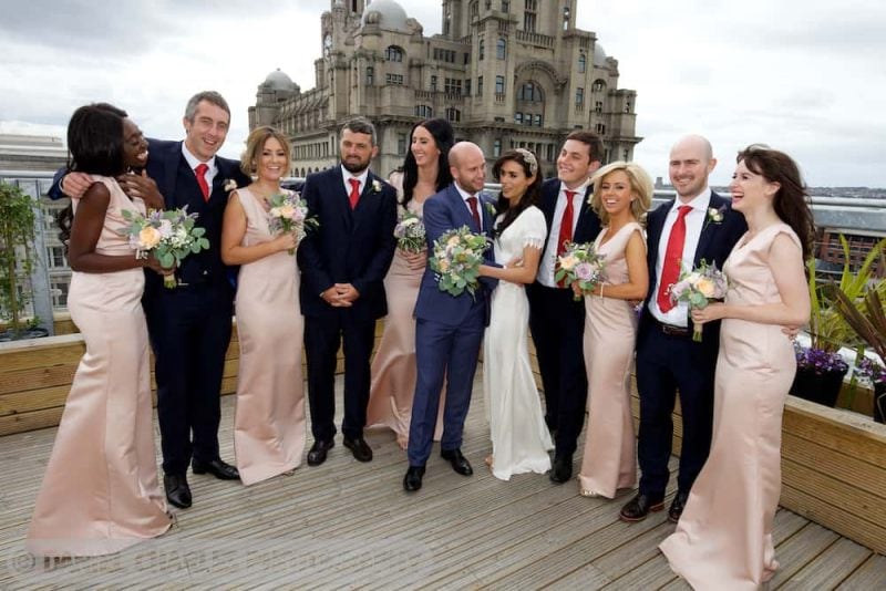 bridal party laughing together on rooftop garden of oh me oh my liverpool