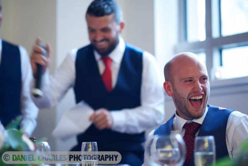groom roaring with laughter at best man's speech liverpool wedding photography