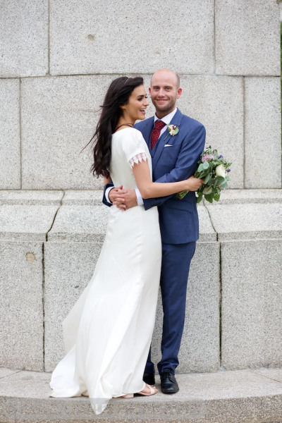 bride and groom embracing by memorial on canada boulevard liverpool