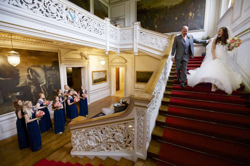 Bride and her father descending main staircase of Knowsley Hall