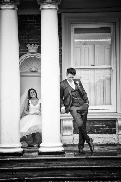bride and groom at side of knowsley hall, black and white wedding photograph