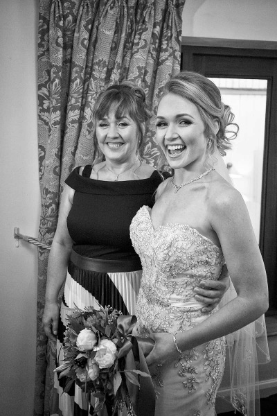a bride and her mother laughing together