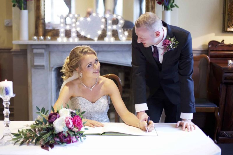 bride and groom signing the register