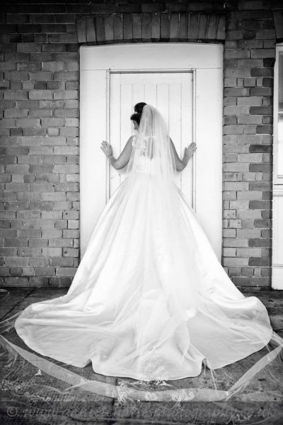 black and white photo showing back of bride's dress